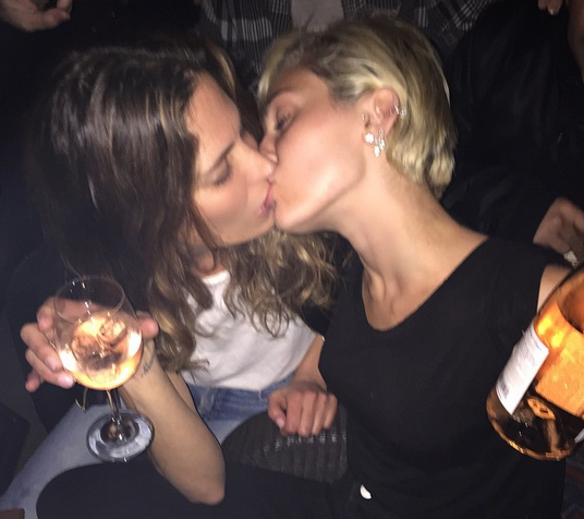 Miley Cyrus pictured passionately locking lips with a girl