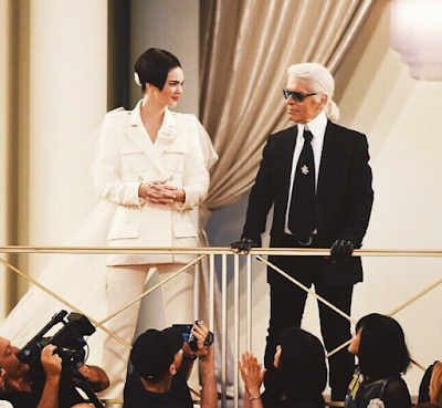 Kendall Jenner takes a picture with fashion icon Karl Lagerfeld