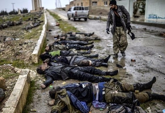 Body of executed ISIS fighters lined up in the ruins of  border town of Kobane